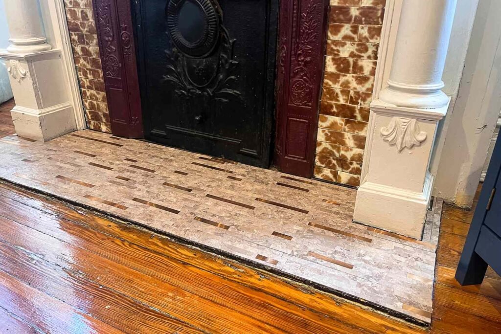Peel and stick floor tiles installed around a fireplace, showing an area where careful installation is important.