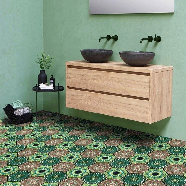 Peel and stick hexagon floor tiles in green and brown floral pattern in a modern bathroom with floating wood vanity