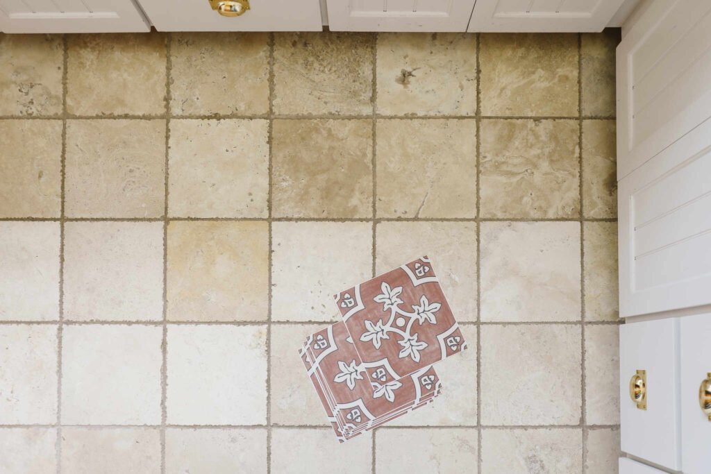 Peel and stick tile placed over an existing ceramic tile floor in a kitchen, showing a simple flooring makeover.